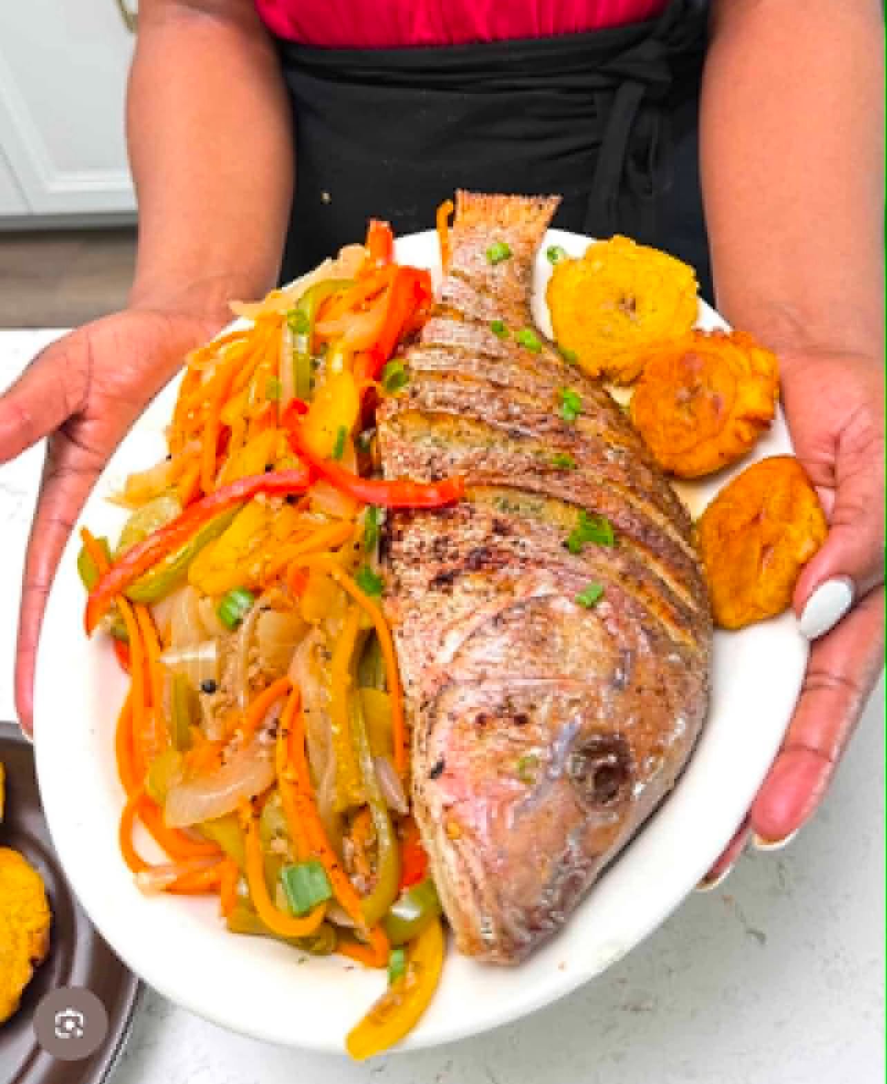Rena's whole escovitch fish topped with peppers, onions and carrots, with fried plantains